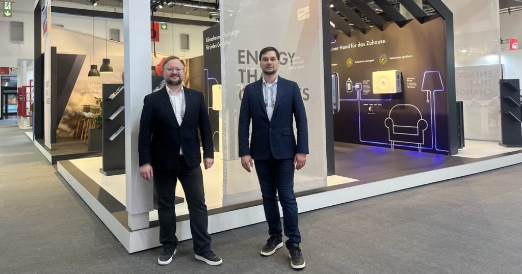 Two Smart Atoms team members at an inverter maker's stand at Light + Building 2026 in Frankfurt