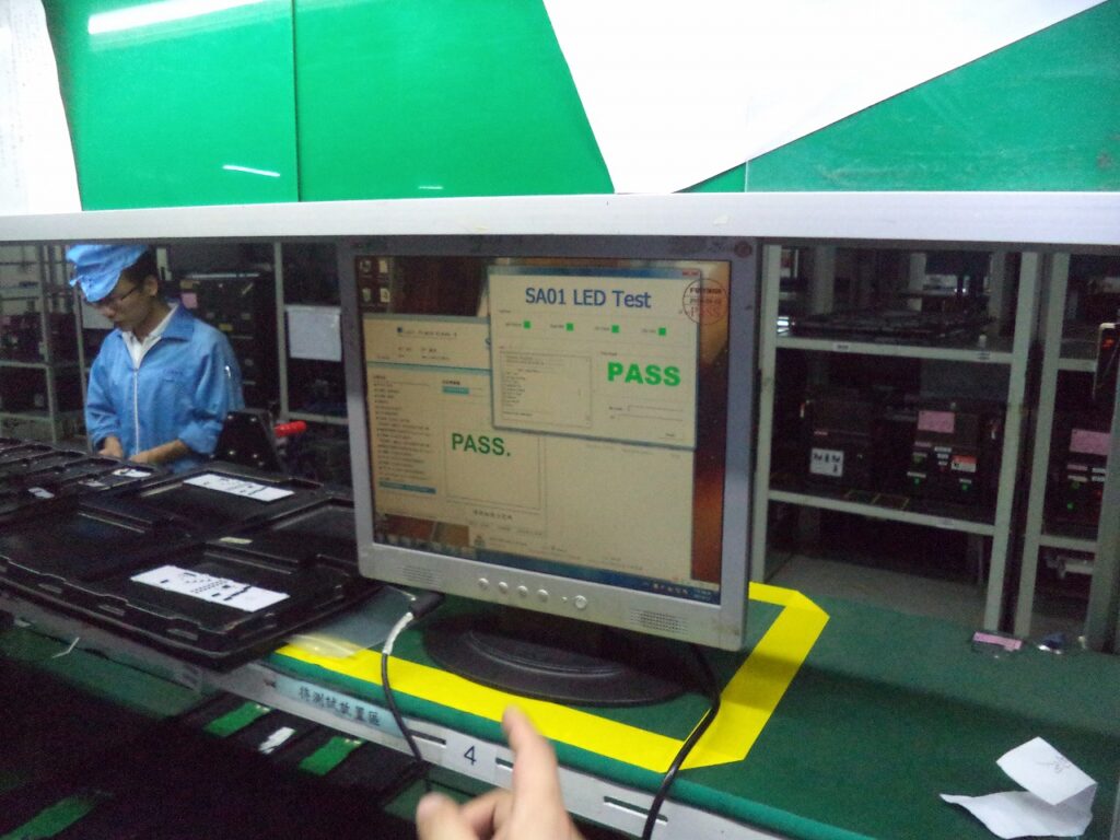 Production test station showing an SA01 LED test PASS result