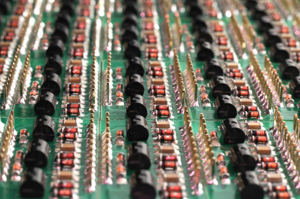 Close-up side view of a PCB board with SMD components