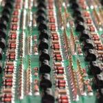 Close-up side view of a PCB board with SMD components