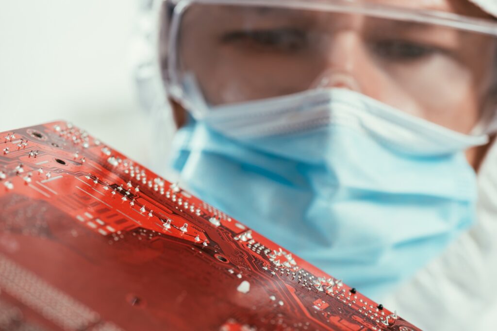 Engineer in a lab holding a circuit board