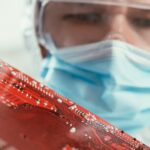 Engineer in a lab holding a circuit board