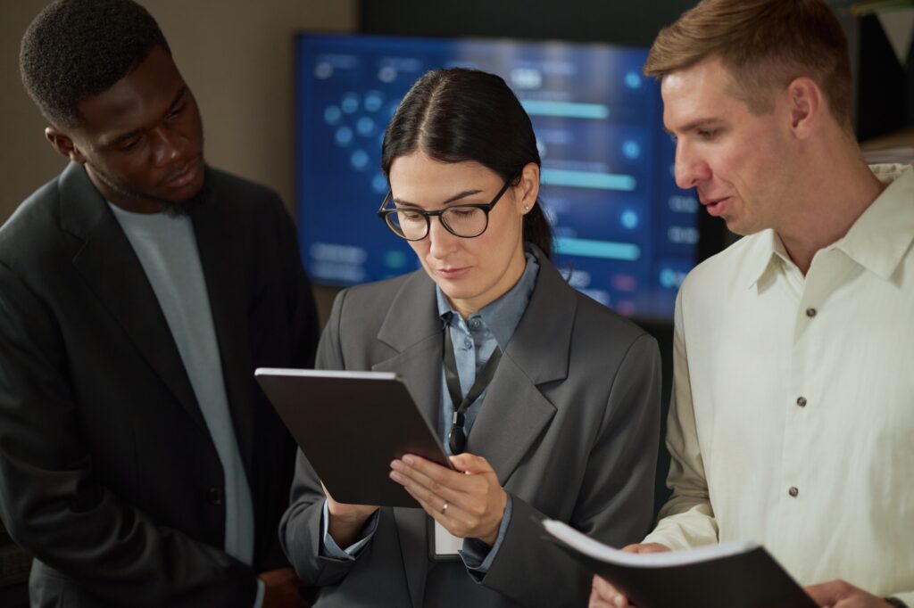Engineers reviewing security documentation on a tablet