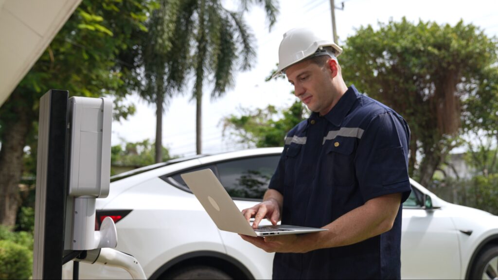 Service technician updating an EV charger with a laptop