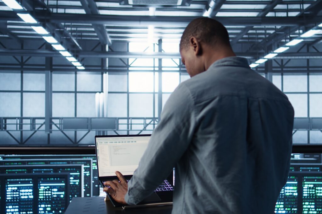 Engineer testing failover on a laptop in a data centre