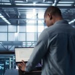 Engineer testing failover on a laptop in a data centre