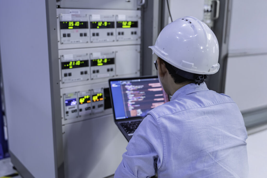 Electrical engineer male checking voltage at the Power Distr