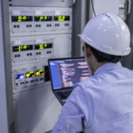 Electrical engineer male checking voltage at the Power Distr