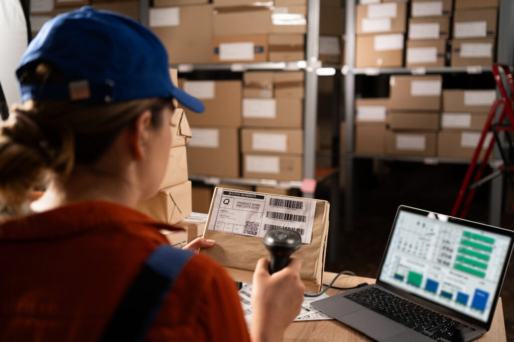 Woman worker working with warehouse management system with b