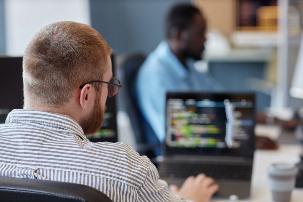 Software engineer reviewing code on a laptop