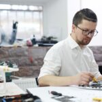Engineer working on electronics with test equipment