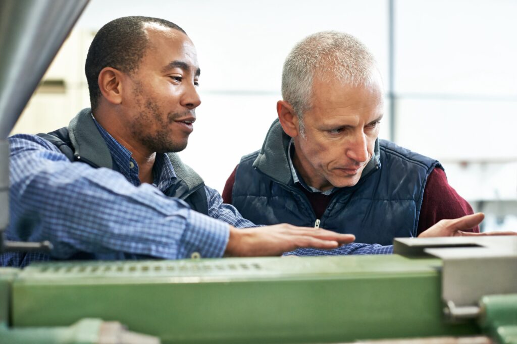 Engineers discussing at a production machine
