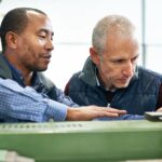 Engineers discussing at a production machine